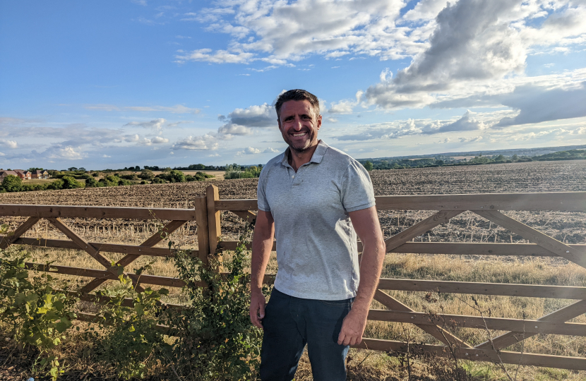 Ben Everitt MP in Hanslope with farmers' fields in the background