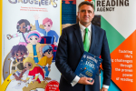 Ben with a book at the Summer Reading Challenge drop-in session in Parliament