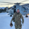 Ben Everitt MP in front of an army helicopter