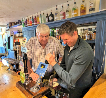 Ben Everitt MP with Cllr Keith McLean pulling a pint of Bell & Bear at the Bell & Bear pub in Emberton