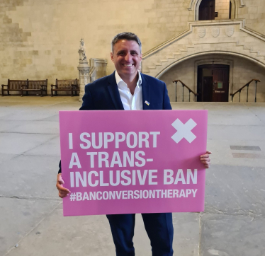 Ben Everitt MP Holding A Trans-Inclusive Conversion Therapy Ban Placard