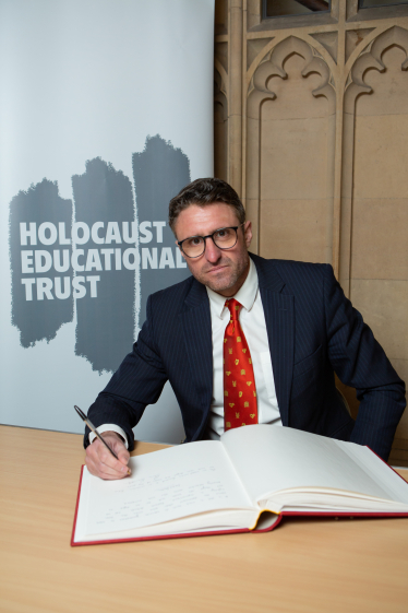 Ben Everitt MP signing the Holocaust Educational Trust Book Of Commitment